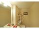 Powder room with vanity, toilet, and storage shelves at 387 Cascade Sw Dr, Lilburn, GA 30047