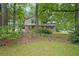 Inviting front view of a charming home surrounded by mature trees and landscaping at 387 Cascade Sw Dr, Lilburn, GA 30047