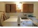 Functional laundry room with modern washer, dryer, and overhead cabinets at 387 Cascade Sw Dr, Lilburn, GA 30047