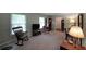 This well-lit living room boasts large windows, a rocking chair, and plenty of space to relax or entertain at 387 Cascade Sw Dr, Lilburn, GA 30047