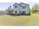 Beautifully landscaped backyard featuring a lush lawn and an inviting view of the home's rear facade at 500 S Hill St, Buford, GA 30518