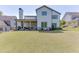 Expansive, well-maintained backyard with lush green lawn, landscaping, and a covered outdoor living space at 500 S Hill St, Buford, GA 30518