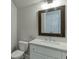 Stylish bathroom with a framed mirror, white vanity with a marble countertop, and chrome fixtures at 500 S Hill St, Buford, GA 30518