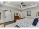 Comfortable bedroom features a trey ceiling, barn door access, ensuite bathroom, and natural light at 500 S Hill St, Buford, GA 30518