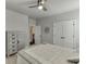 Inviting bedroom featuring a decorative accent, chest of drawers, double closets, and plush carpeting at 500 S Hill St, Buford, GA 30518