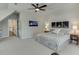 Bright bedroom featuring a ceiling fan, three framed pictures, a comfortable queen-sized bed, and two bedside tables at 500 S Hill St, Buford, GA 30518