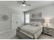 Comfortable bedroom with a ceiling fan, an accent wall decoration, and a queen bed, perfect for relaxation at 500 S Hill St, Buford, GA 30518