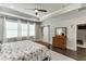 Bright bedroom features a ceiling fan, sliding door, ensuite bathroom, and natural light at 500 S Hill St, Buford, GA 30518