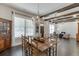 Light-filled dining area with wooden table set, chandelier, and views to the entryway and living area at 500 S Hill St, Buford, GA 30518