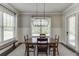 Dining area with large window, wooden table, and chandelier, perfect for Gathering gatherings at 500 S Hill St, Buford, GA 30518