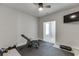 Functional home gym equipped with an exercise bench, a TV, and cushioned flooring for comfortable workouts at 500 S Hill St, Buford, GA 30518