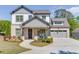 Charming two-story home with a brick and siding exterior, complemented by a well-manicured lawn and inviting front porch at 500 S Hill St, Buford, GA 30518