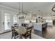 Bright, open kitchen with white cabinets, stainless steel appliances, and large island with barstool seating at 500 S Hill St, Buford, GA 30518