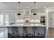 Kitchen island with barstool seating and white countertops, perfect for casual dining at 500 S Hill St, Buford, GA 30518