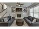 Spacious living room with a fireplace, built-in cabinets, shiplap accent wall, and dark hardwood floors at 500 S Hill St, Buford, GA 30518