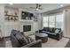 Bright living room featuring shiplap accent wall, fireplace, and shelving beside large windows at 500 S Hill St, Buford, GA 30518
