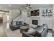 Spacious living room with a fireplace, built-in cabinets, shiplap accent wall, and dark hardwood floors at 500 S Hill St, Buford, GA 30518