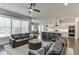 Open floor plan with a view of a modern kitchen, living area with leather sofas, and dining area at 500 S Hill St, Buford, GA 30518