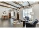Spacious living area featuring dark hardwood floors, stylish furniture, and a dining area with a rustic table at 500 S Hill St, Buford, GA 30518
