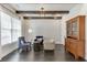 Cozy sitting area featuring hardwood floors, beamed ceilings, a vintage hutch, and comfortable seating at 500 S Hill St, Buford, GA 30518