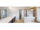 Bathroom featuring a double sink vanity and tiled shower at 881 Upland Ives Dr, Sugar Hill, GA 30518