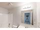 Bathroom with white vanity, and shower featuring a large mirror reflecting a tripod at 881 Upland Ives Dr, Sugar Hill, GA 30518