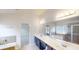 Bathroom featuring a double vanity sink and soaking tub at 881 Upland Ives Dr, Sugar Hill, GA 30518