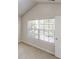 Carpeted bedroom with a large window and neutral paint, ready for personal touches at 881 Upland Ives Dr, Sugar Hill, GA 30518