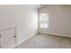 Well-lit bedroom features neutral paint, carpeting, and a window with views of the outdoors at 881 Upland Ives Dr, Sugar Hill, GA 30518