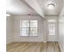 Bright dining room features elegant wainscoting, wood floors, natural light, and a glass door at 881 Upland Ives Dr, Sugar Hill, GA 30518