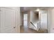 Upstairs hallway with white trim and neutral carpet at 881 Upland Ives Dr, Sugar Hill, GA 30518