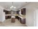 Modern kitchen with dark wood cabinets, stainless steel appliances, and a center island at 881 Upland Ives Dr, Sugar Hill, GA 30518