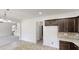 Open-concept layout featuring a kitchen, a staircase and a living room in the background at 881 Upland Ives Dr, Sugar Hill, GA 30518
