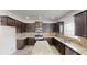 Spacious kitchen featuring granite counters, stainless appliances, and a functional center island at 881 Upland Ives Dr, Sugar Hill, GA 30518