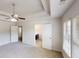 Main bedroom with ceiling fan, tray ceiling, and bathroom access at 881 Upland Ives Dr, Sugar Hill, GA 30518