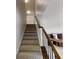 Carpeted staircase leading to upper level, adjacent to the kitchen at 881 Upland Ives Dr, Sugar Hill, GA 30518
