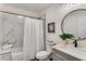 Bathroom with shower-tub combo featuring marble tiling, white shower curtain and modern black fixtures at 1062 Grant Ter Se, Atlanta, GA 30315