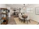 Bright dining area with gray kitchen in background, modern lighting, and wood flooring at 1062 Grant Ter Se, Atlanta, GA 30315
