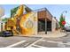 Unique exterior with a colorful mural and modern architecture, featuring outdoor seating and street parking at 1062 Grant Ter Se, Atlanta, GA 30315