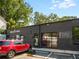 Modern commercial exterior featuring black brick, glass garage door, and signage for Noble Clay Fitness and Poach Social at 1062 Grant Ter Se, Atlanta, GA 30315