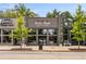 Exterior of Press Shop, with modern storefront windows and signage, complemented by landscaping and street trees at 1062 Grant Ter Se, Atlanta, GA 30315