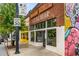 Exterior view of Little Bear with a red brick facade, large windows, and colorful street art nearby at 1062 Grant Ter Se, Atlanta, GA 30315
