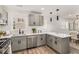 Well-lit kitchen boasts stainless steel appliances, gray cabinetry, and sleek countertops, creating a modern and functional space at 1062 Grant Ter Se, Atlanta, GA 30315
