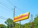 Sign for NeighborGoods displaying the name, surrounded by trees and utility poles against a clear blue sky at 1062 Grant Ter Se, Atlanta, GA 30315