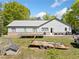 A single story home and its backyard, complete with playground, and a large flatbed trailer at 2909 Jones Mill Rd, Atlanta, GA 30360