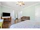 Spacious bedroom with a ceiling fan, hardwood floors, and an ensuite bathroom at 2909 Jones Mill Rd, Atlanta, GA 30360