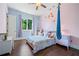 ' bedroom with hardwood floors, a ceiling fan, a fun hammock, and a large window at 2909 Jones Mill Rd, Atlanta, GA 30360