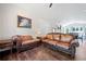 Spacious living room with hardwood floors, neutral walls, plenty of sunlight and comfortable leather sofas at 2909 Jones Mill Rd, Atlanta, GA 30360