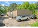 A large metal outbuilding with multiple cars and work vehicles around it at 2909 Jones Mill Rd, Atlanta, GA 30360
