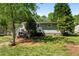 Exterior view of a home's backyard featuring a deck, lush lawn, mature trees, and a few ducks in the lawn at 3099 Dove Way, Decatur, GA 30033